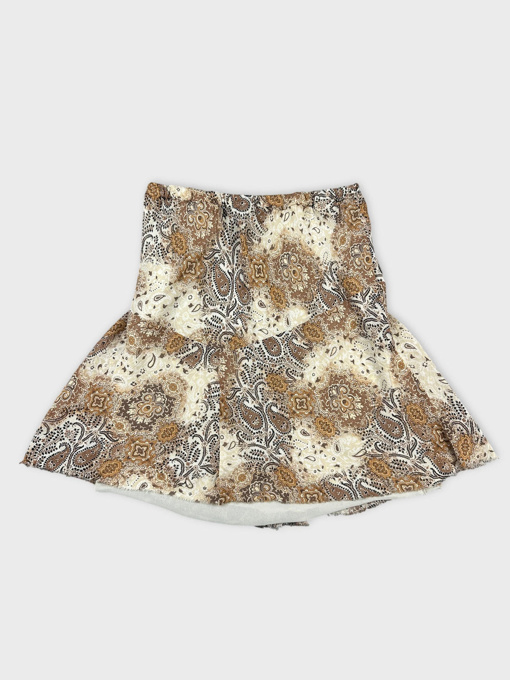 Front view of a patterned brown and cream skirt with a skirt flounce.