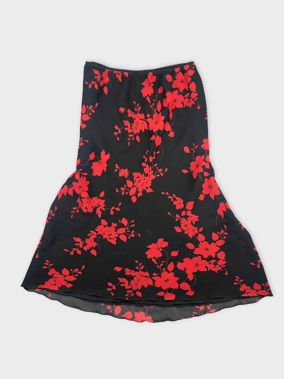 Front view of a black skirt with red floral pattern.