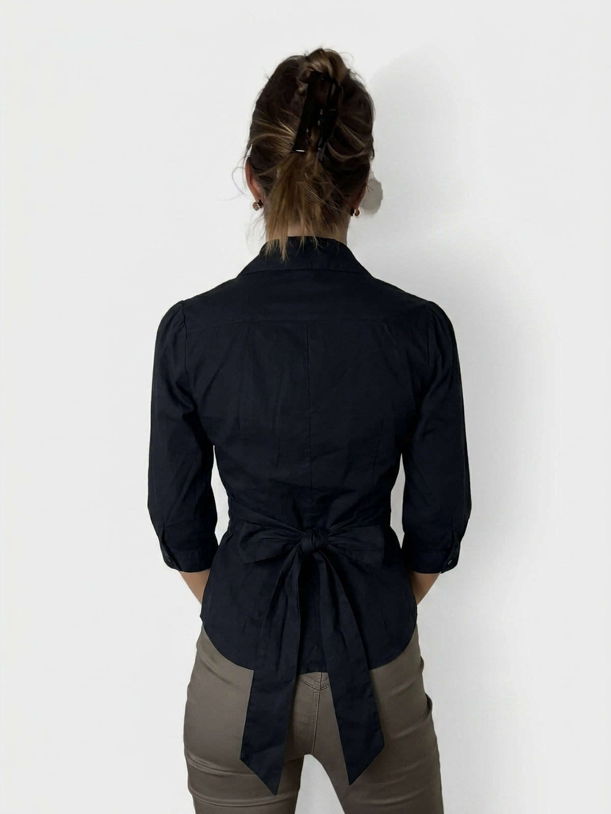Back view of a dark navy vintage shirt with a bow detail.