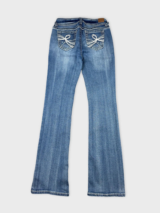 Back view of wide jeans in blue with embroidered pocket details.