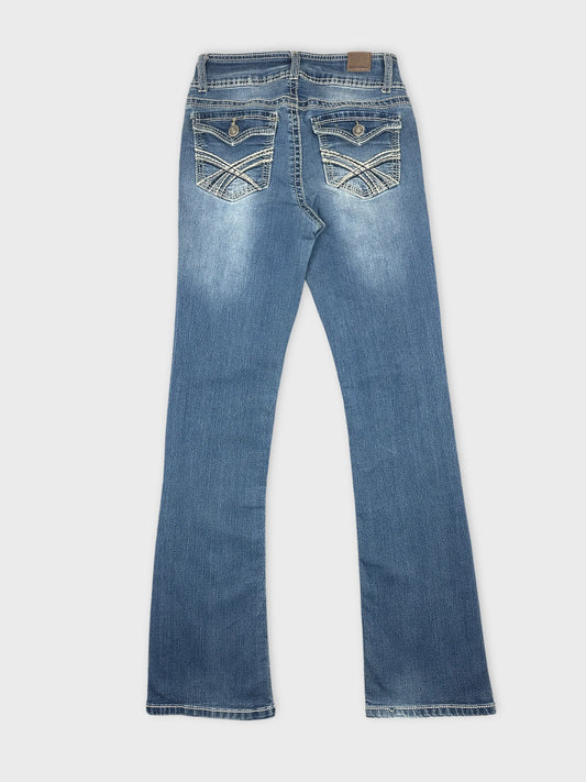 Back view of women denim jeans in light blue with embroidered pockets.