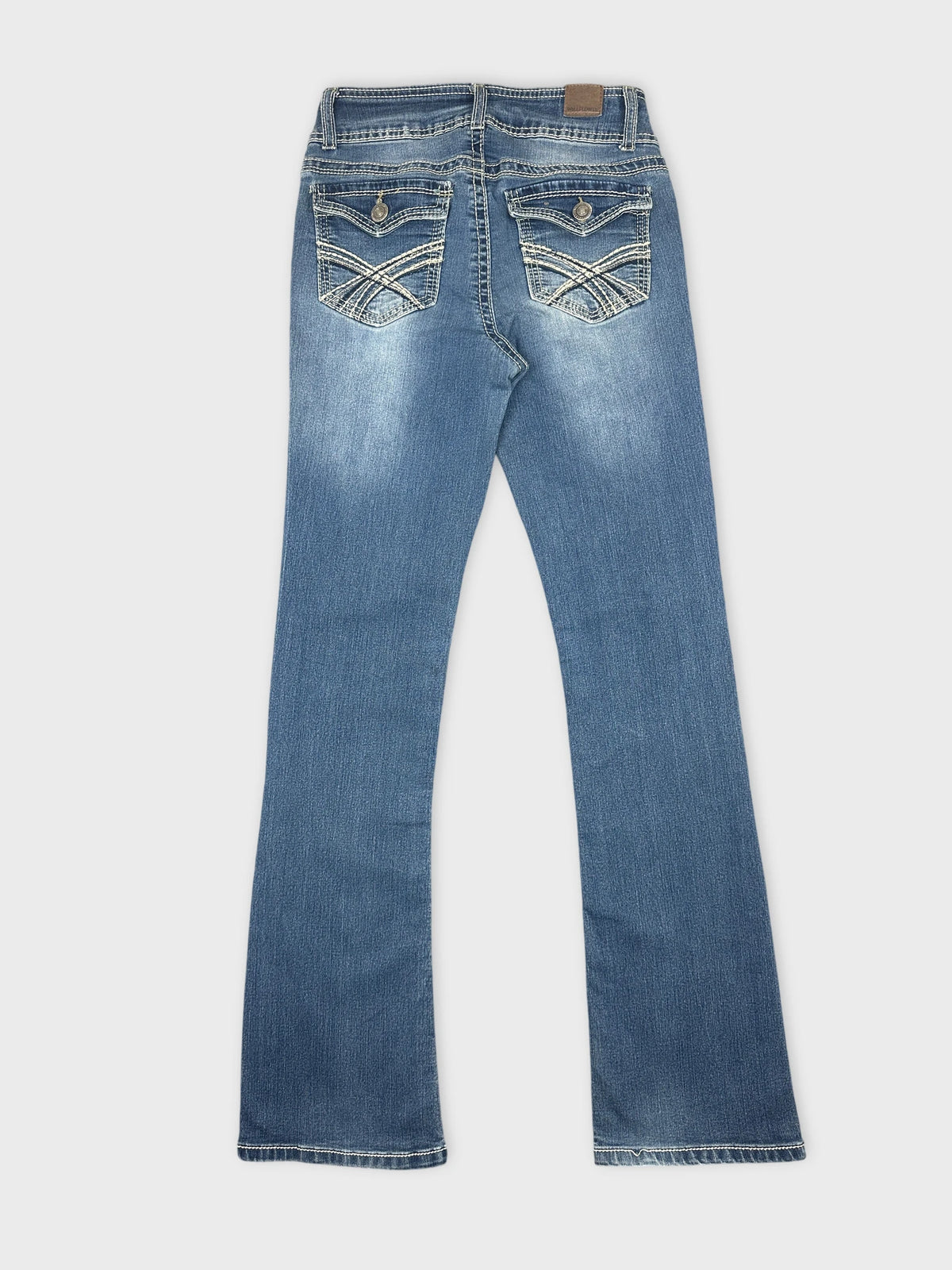 Back view of women denim jeans in light blue with embroidered pockets.