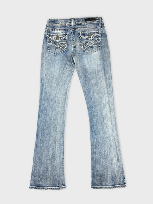 Back view of women denim jeans in light blue with detailed rear pockets.