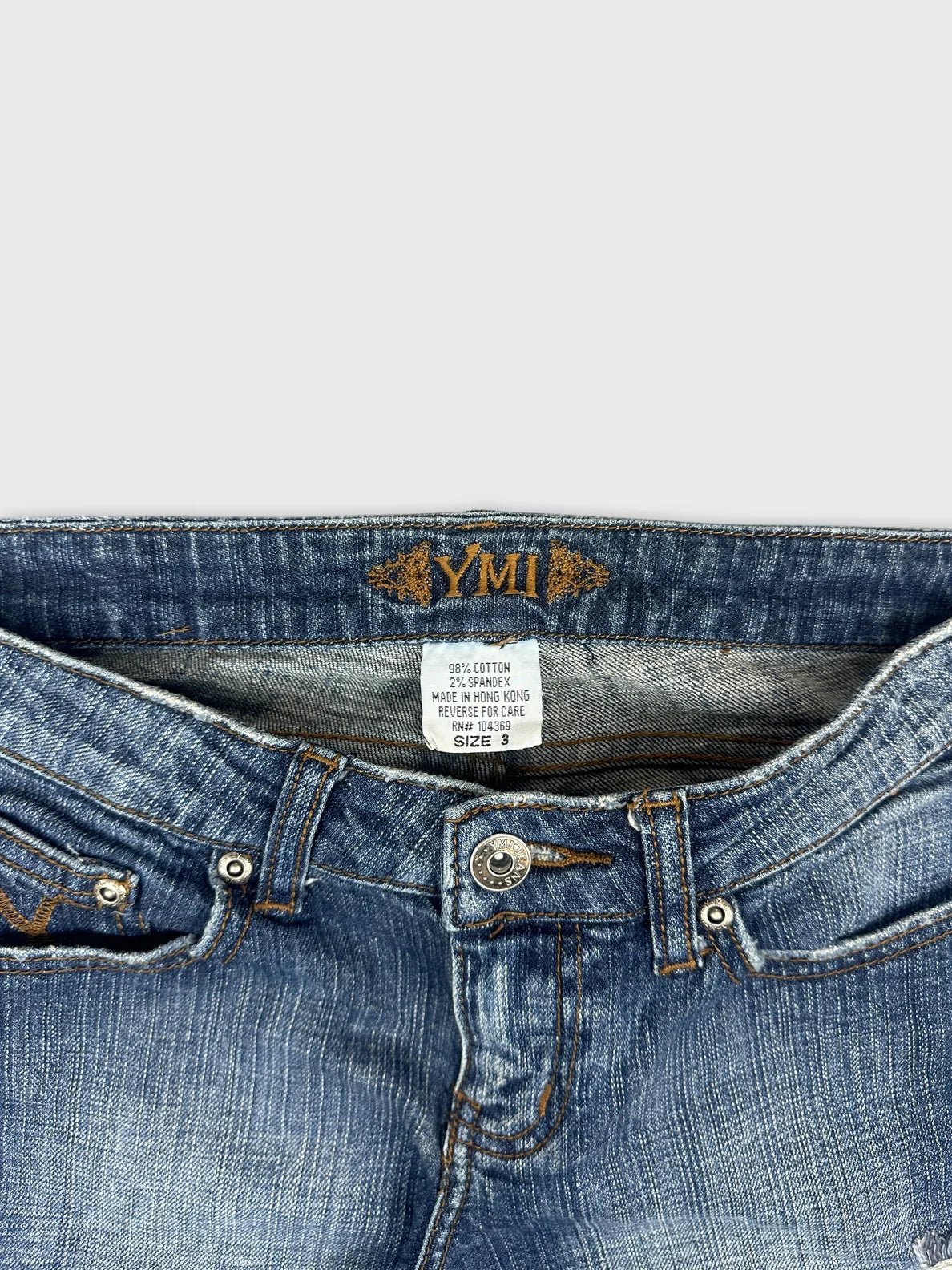 Detail view of women denim jeans in blue with subtle ribbed texture.