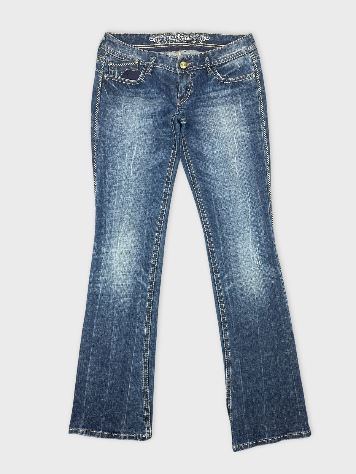 Front view of women denim jeans in dark blue with faded wash details.