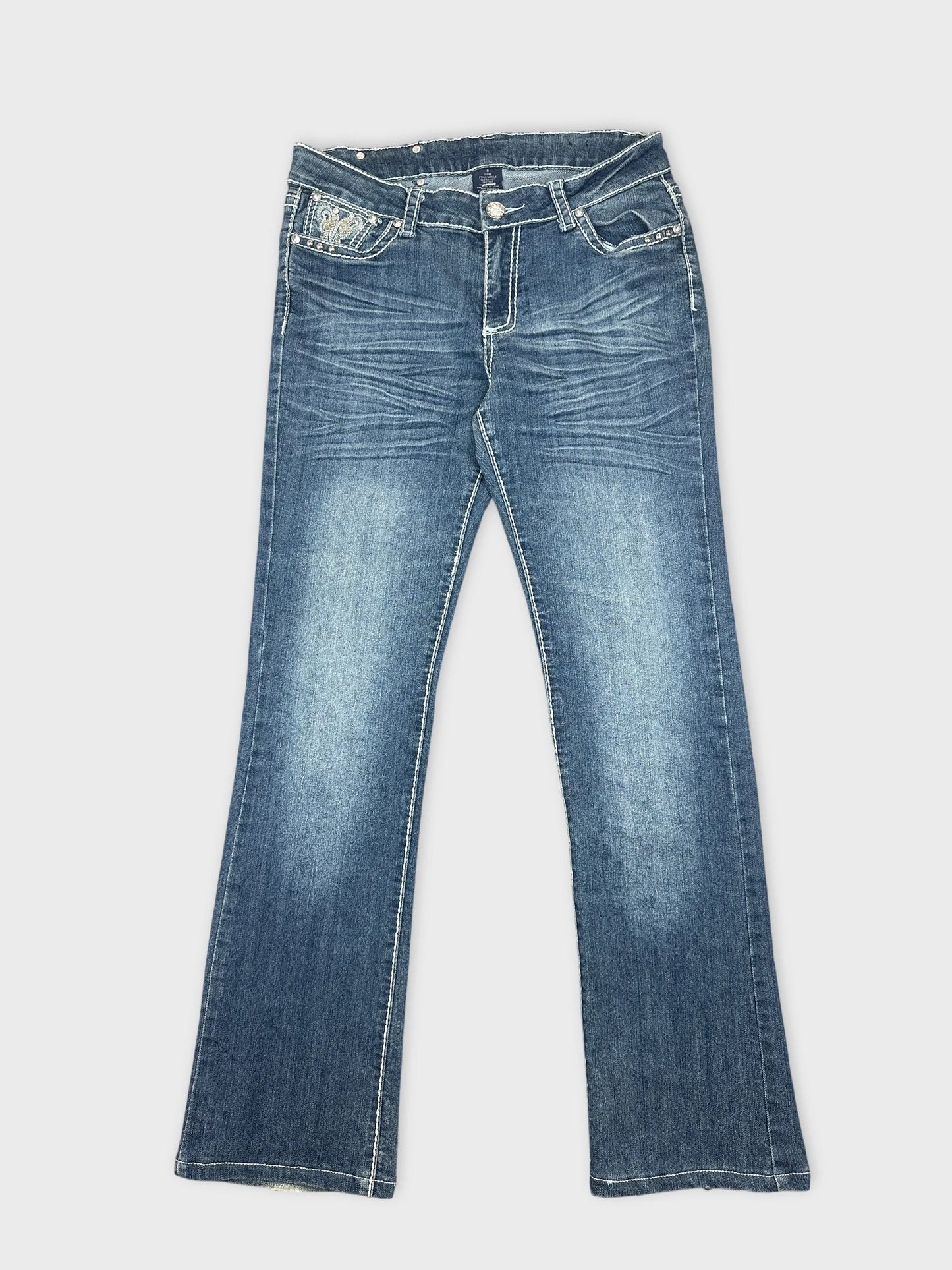 Front view of women's denim jeans in dark blue with embroidered detail on pockets.