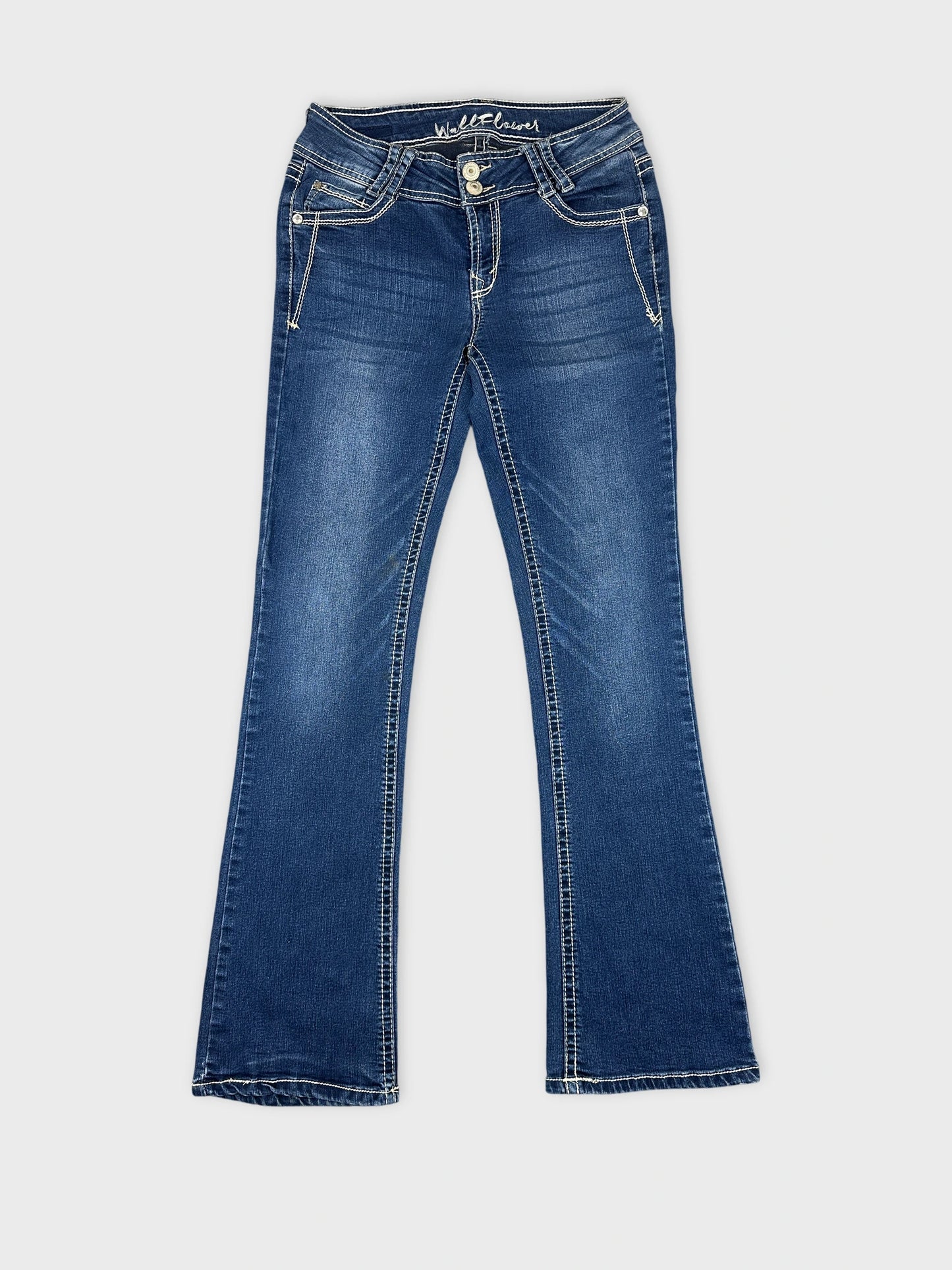 Front view of women denim jeans in dark blue with flared shape.