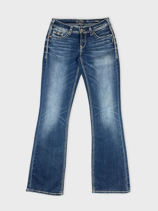 Front view of women denim jeans in dark blue with contrast stitching.