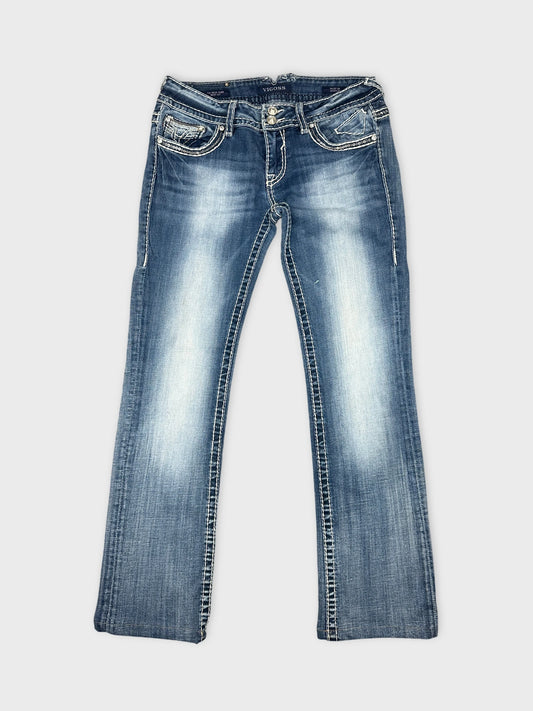 Front view of blue denim jeans with decorative stitching and pockets.