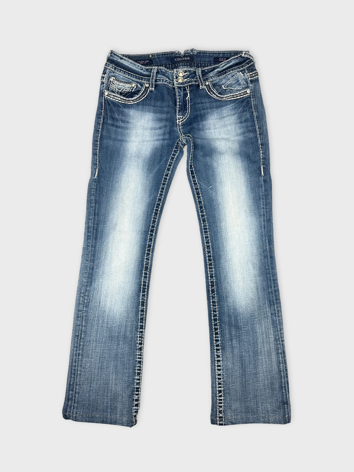 Front view of blue denim jeans with decorative stitching and pockets.
