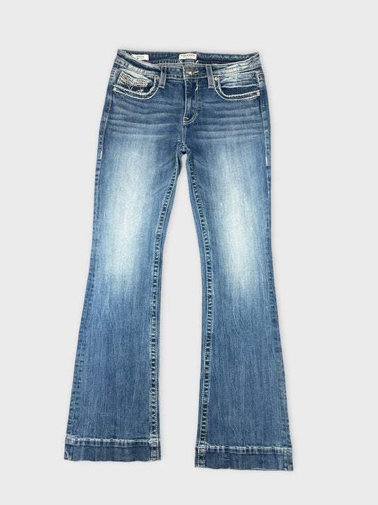 Front view of flared women denim jeans in light blue with pocket details.
