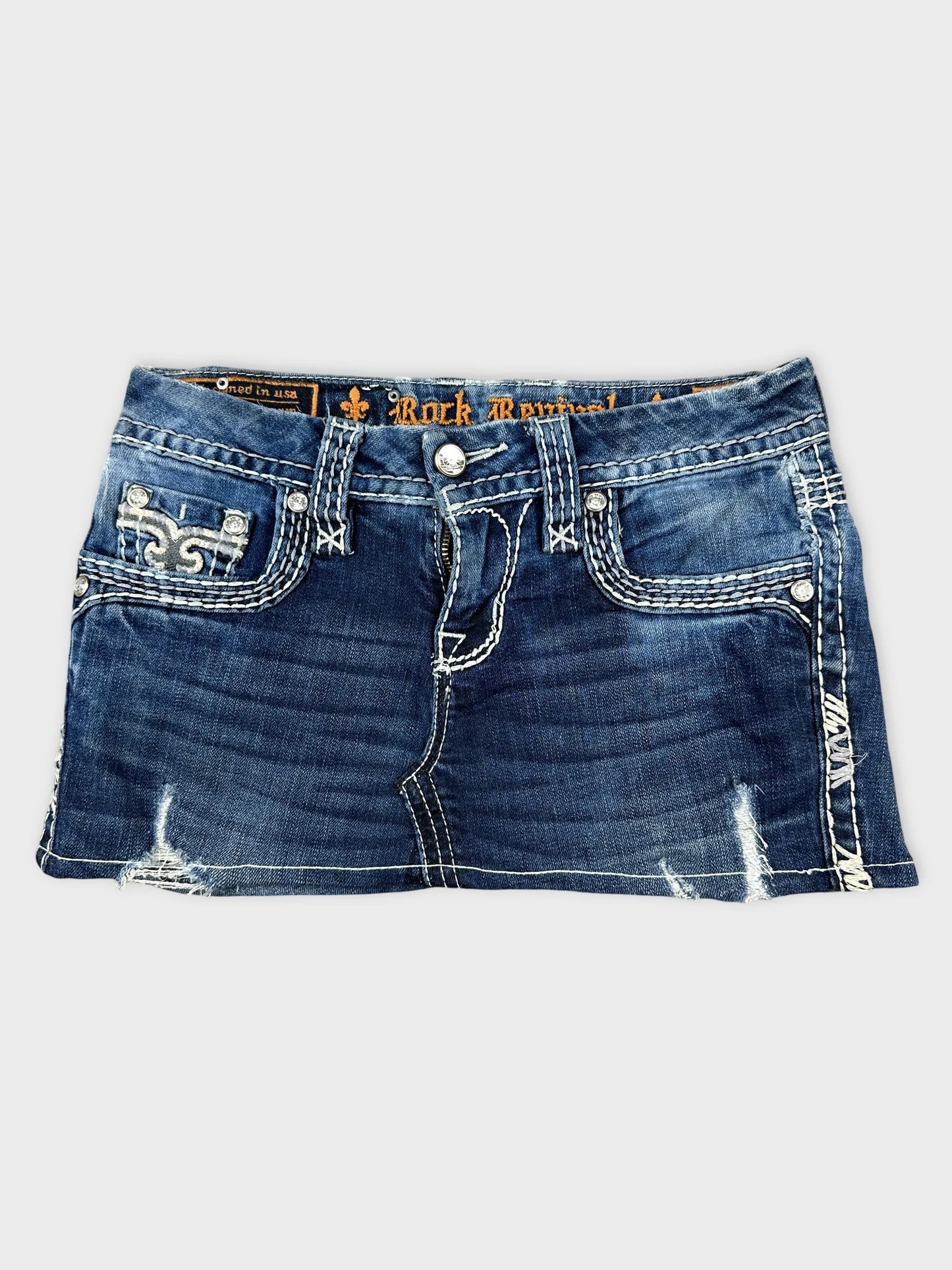 Front view of a women's denim shirt in dark blue with decorative stitching.