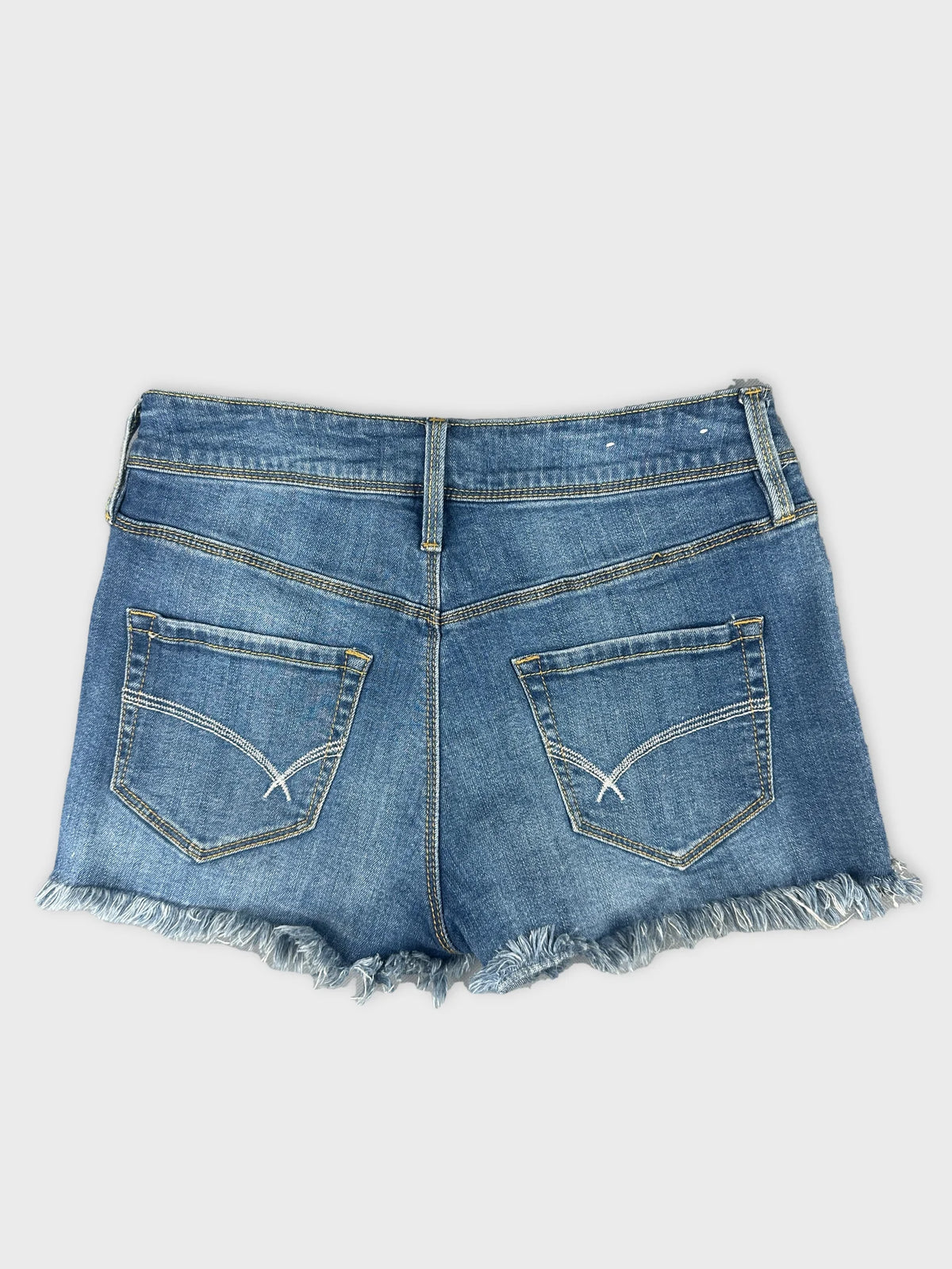 Back view of women denim shorts in light blue with frayed hem.