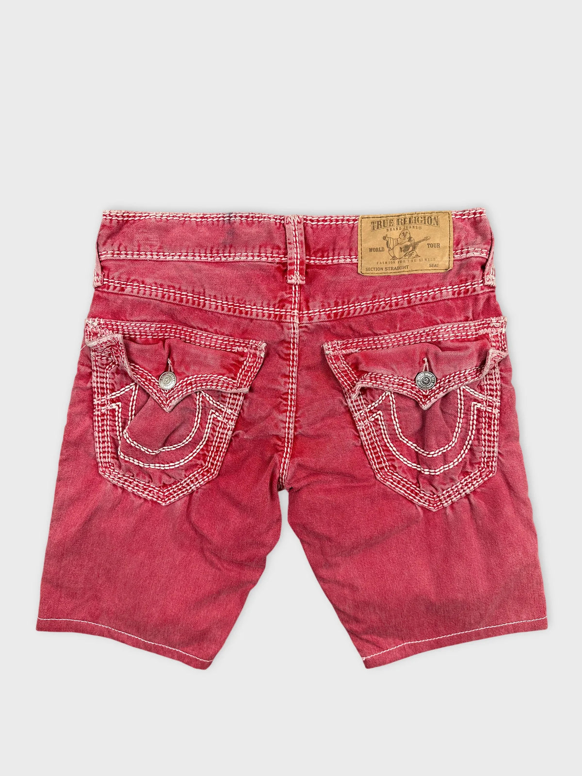Back view of red denim shorts featuring embroidered pocket details.