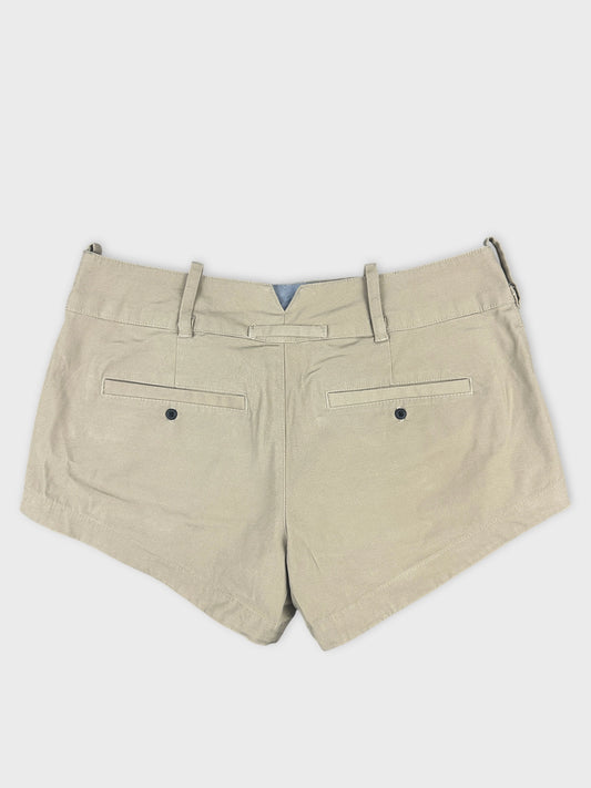 Back view of beige denim shorts featuring two back pockets.