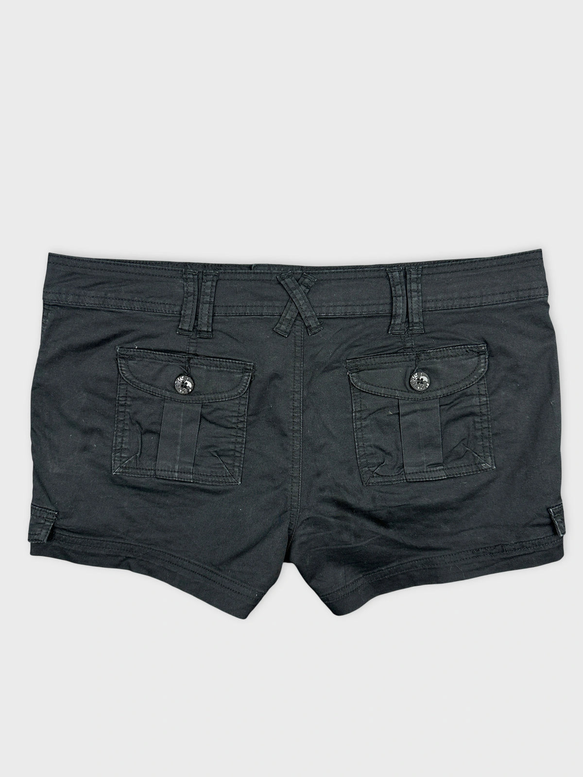 Back view of black denim shorts featuring two back pockets.