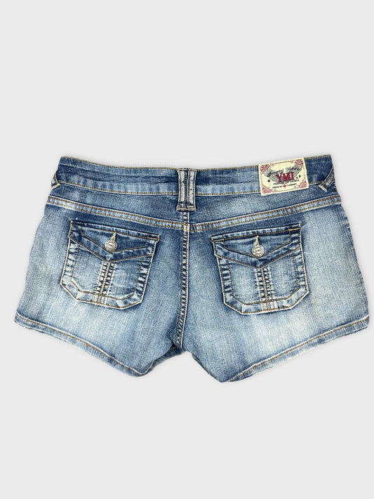 Back view of women's denim shorts in light blue with decorative pockets.