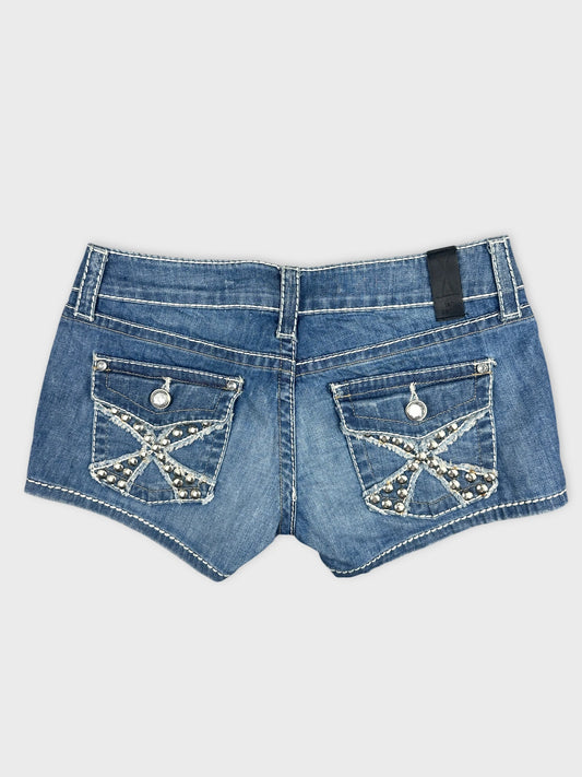 Back view of blue denim shorts with decorative pocket designs.
