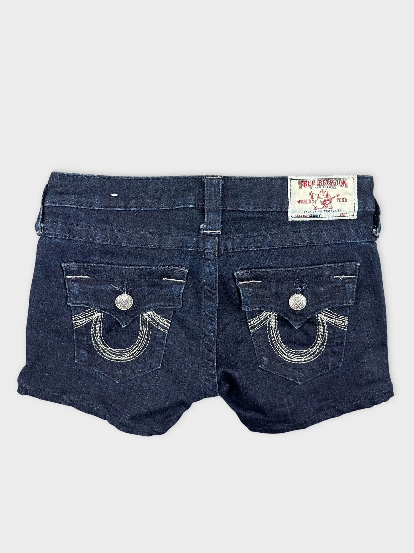Back view of women's denim shorts in dark blue with detailed stitching.
