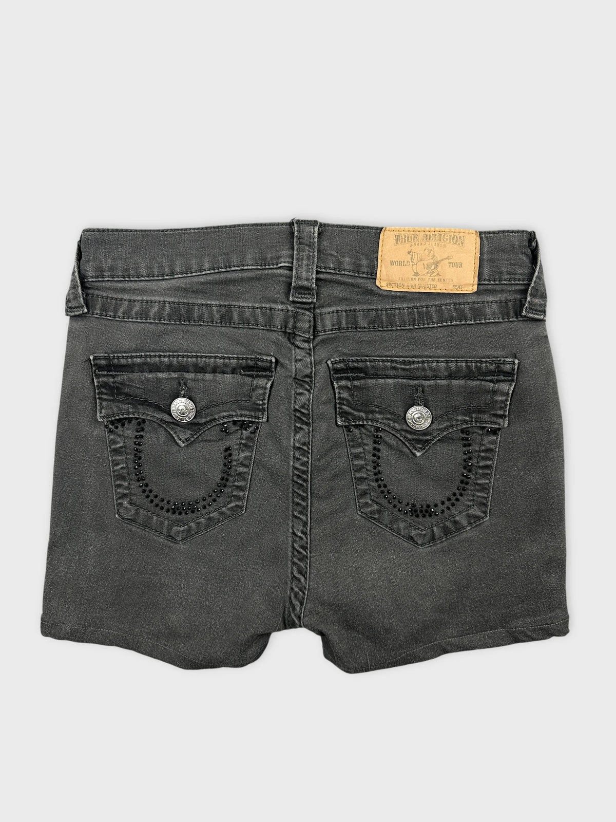 Back view of black denim shorts featuring embellished back pockets.