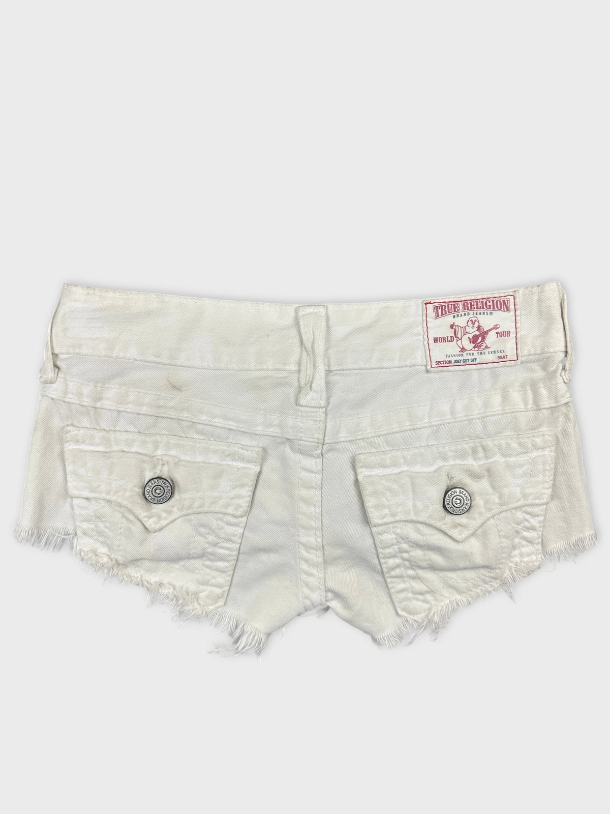 Back view of white denim shorts with frayed hem and pockets.