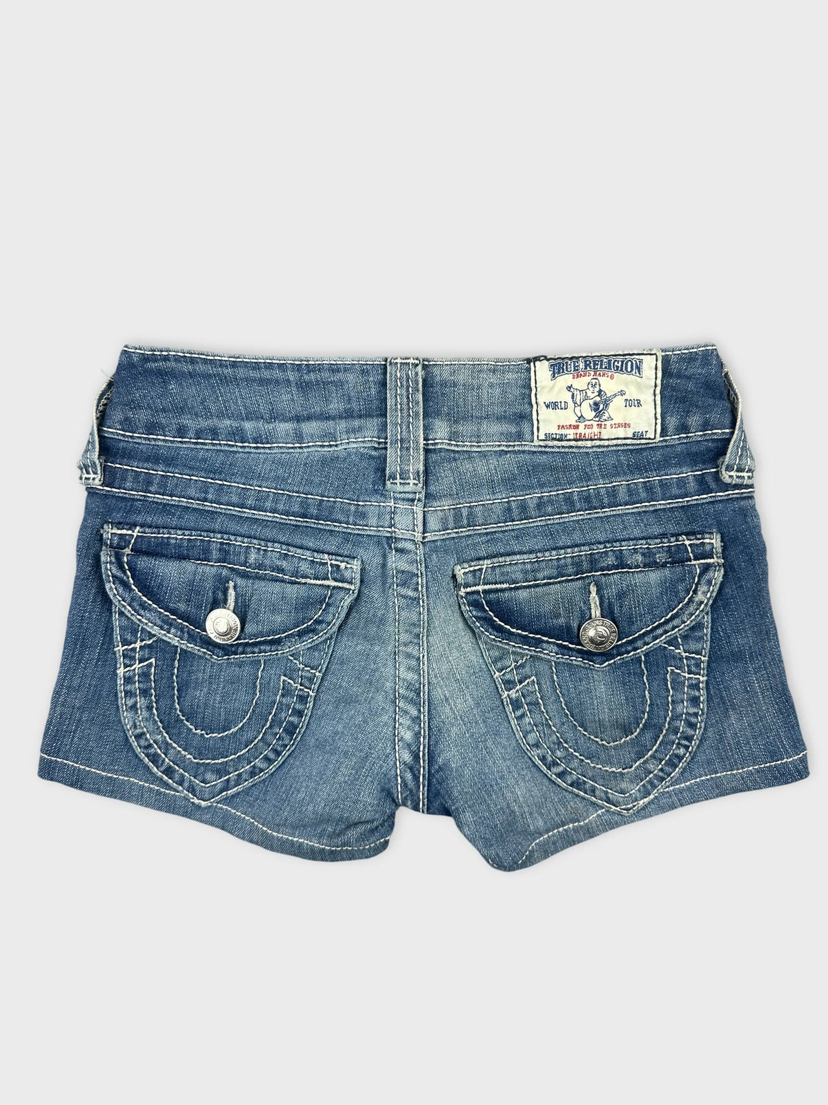 Back view of women denim shorts in light blue with decorative pockets.
