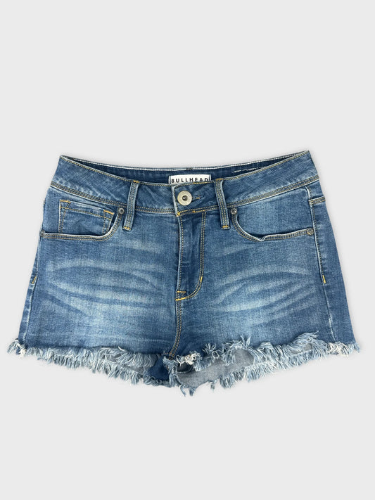 Front view of women denim shorts featuring frayed hem and faded blue color.