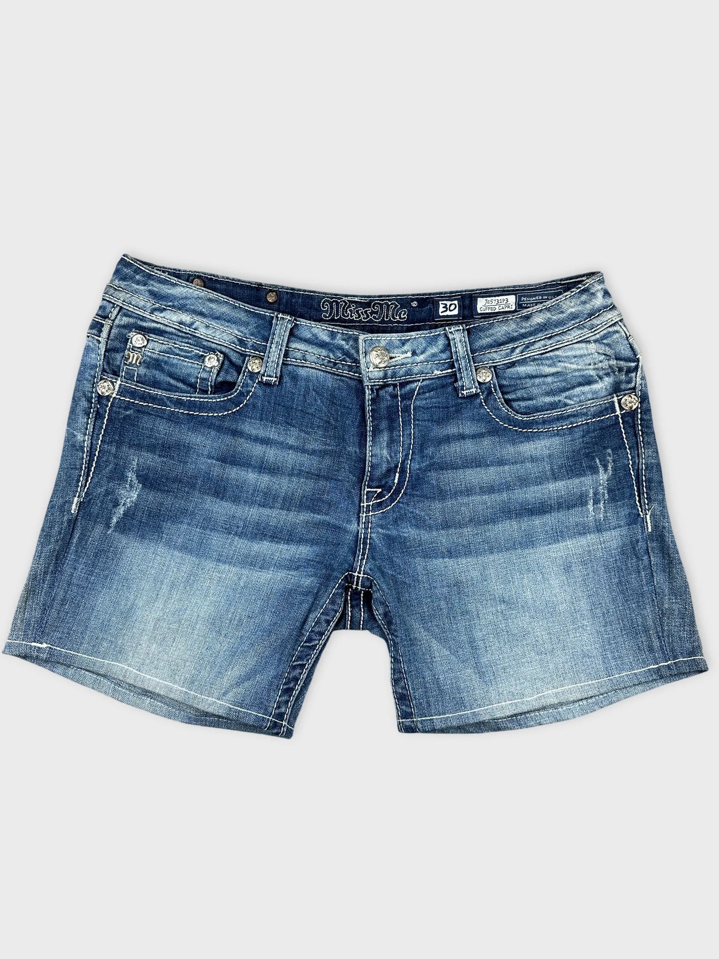 Front view of women's denim shorts in light blue with distressed detailing.