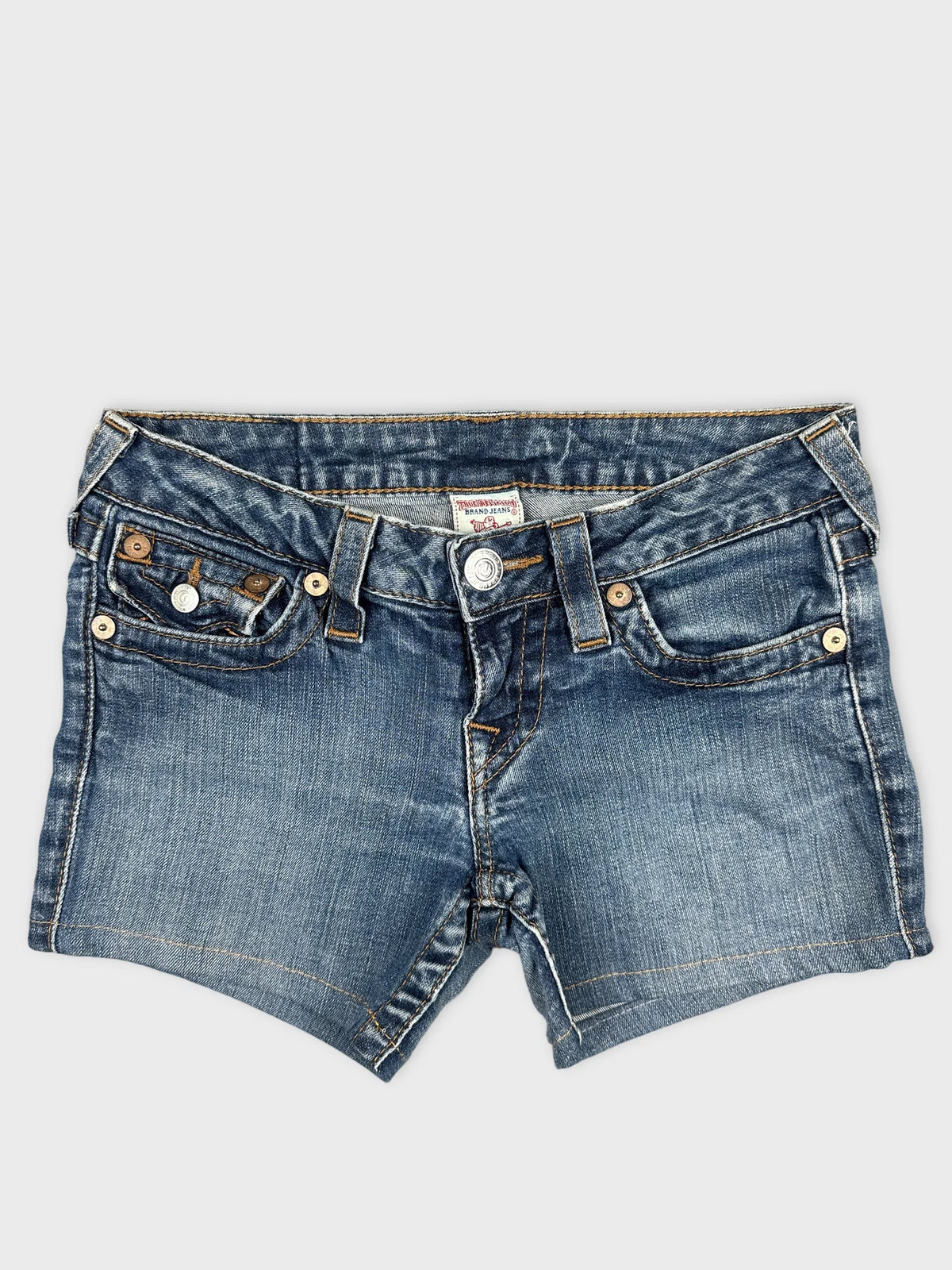 Front view of women denim shorts in faded blue with button details.