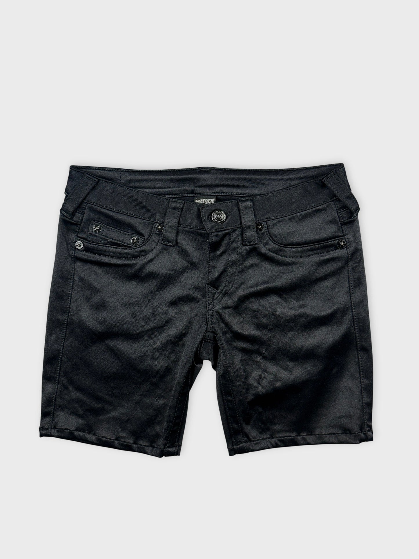 Front view of black denim shorts featuring front pockets and button detail.