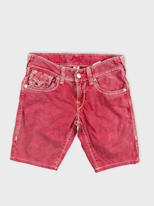 Front view of red denim shorts featuring contrasting stitching details.