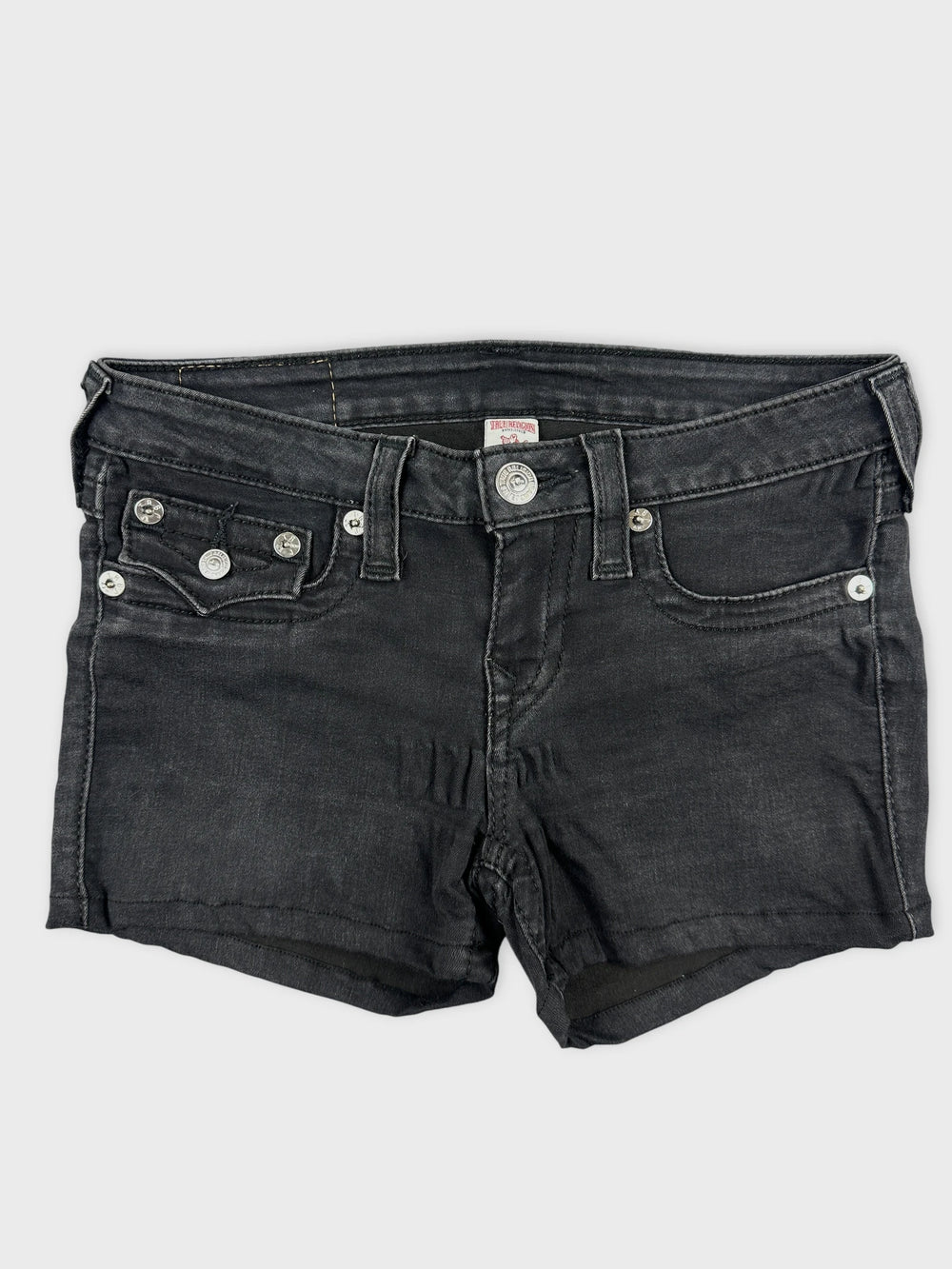 Front view of black denim shorts with silver button details and pockets.