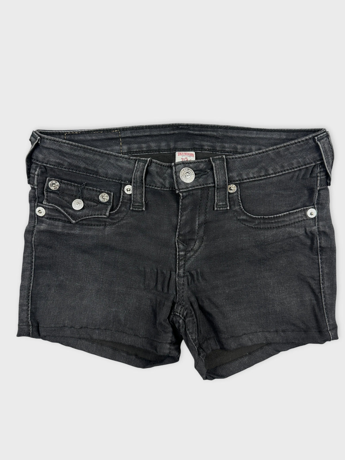 Front view of black denim shorts with silver button details and pockets.