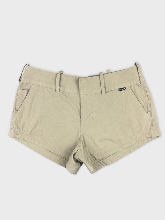 Front view of beige denim shorts featuring belt loops and side pockets.