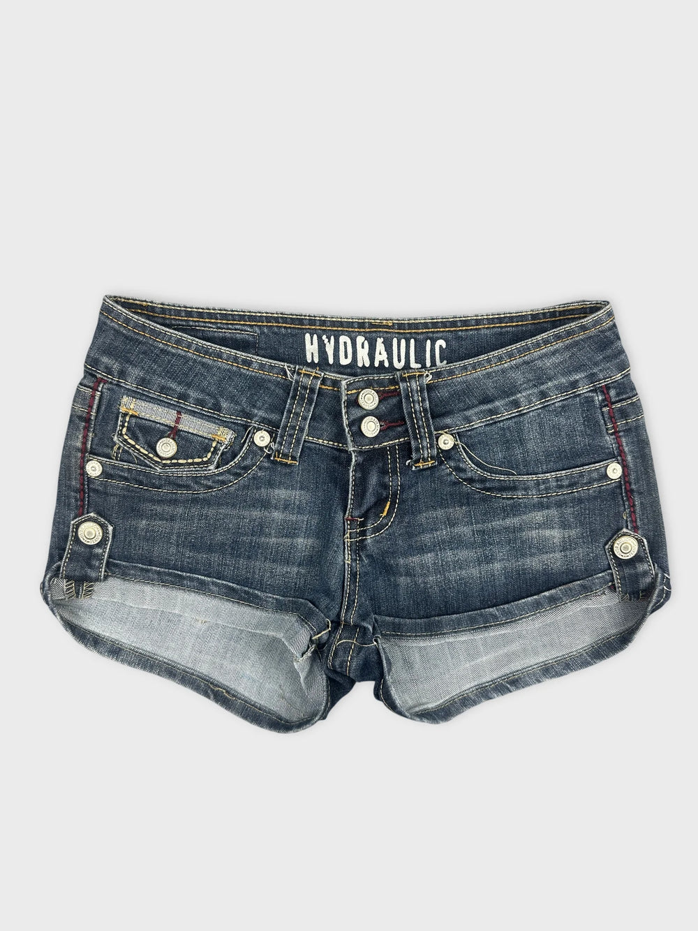 Front view of women's denim shorts in dark blue with button details.