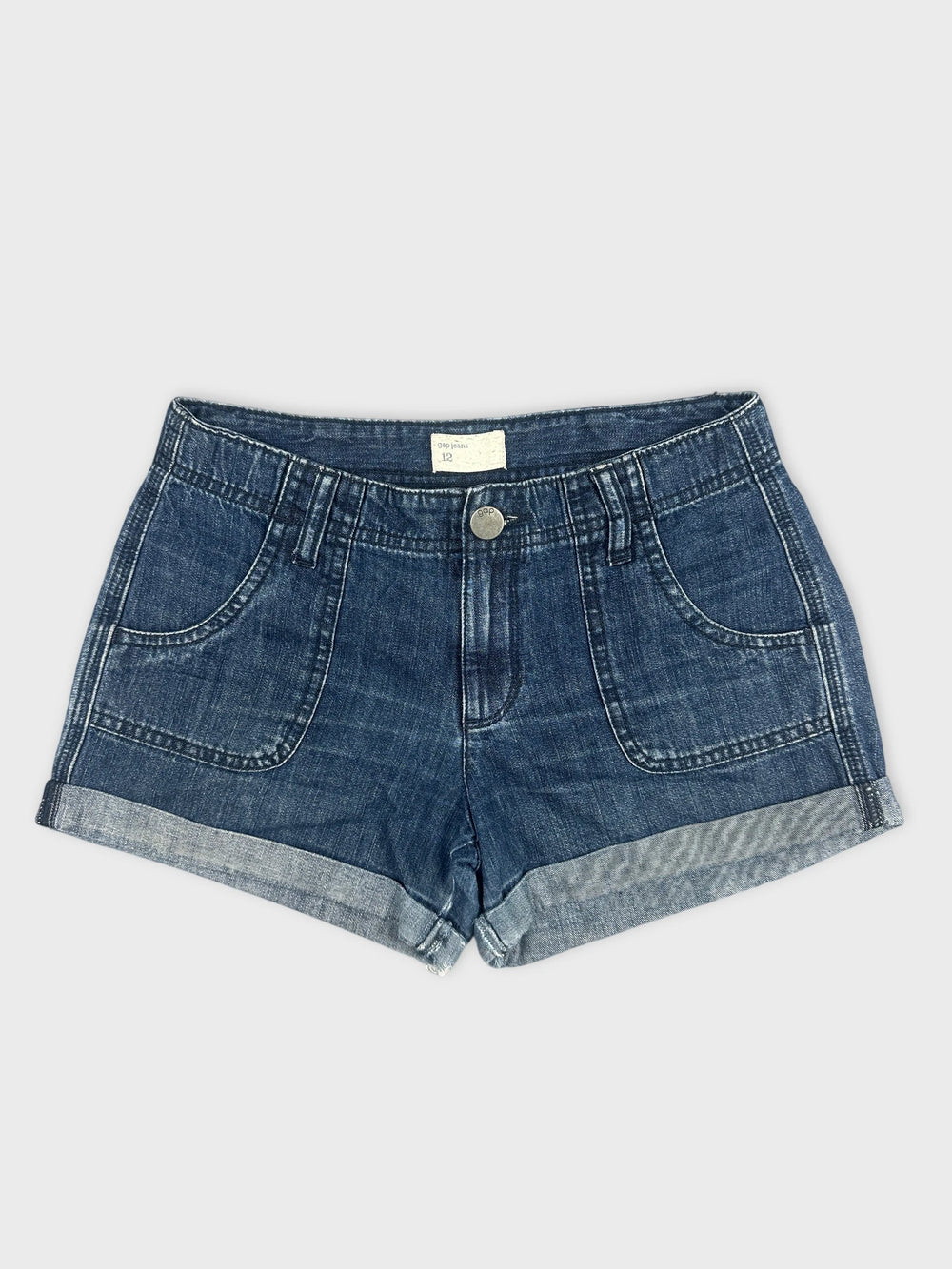 Front view of women denim shorts in dark blue with rolled hem.