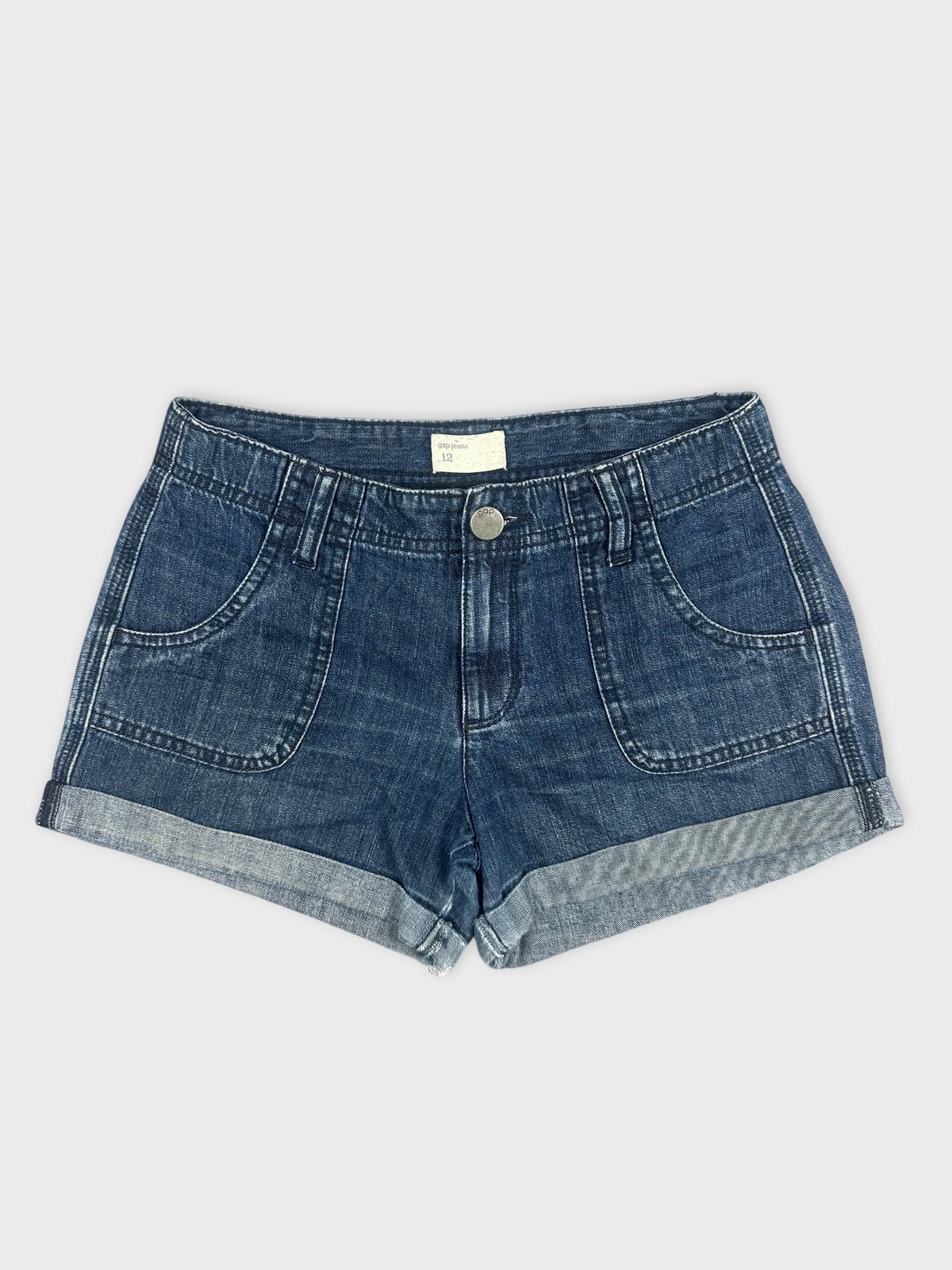 Front view of women denim shorts in dark blue with rolled hem.