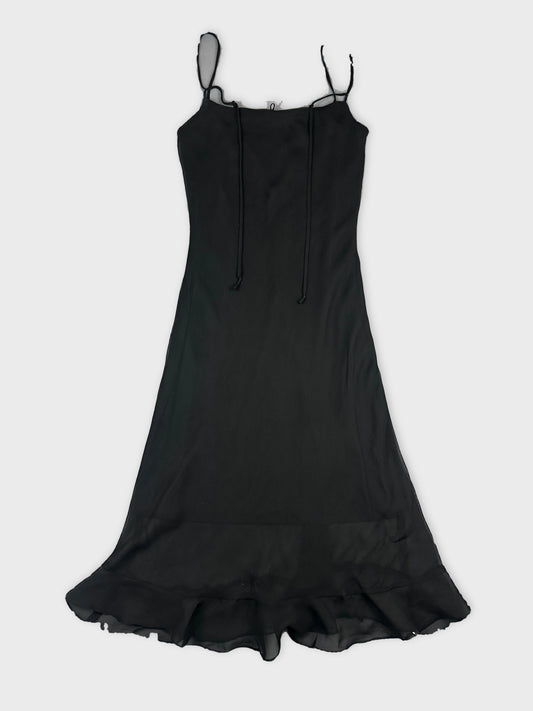 Black long dress with ruffled hem in front view.