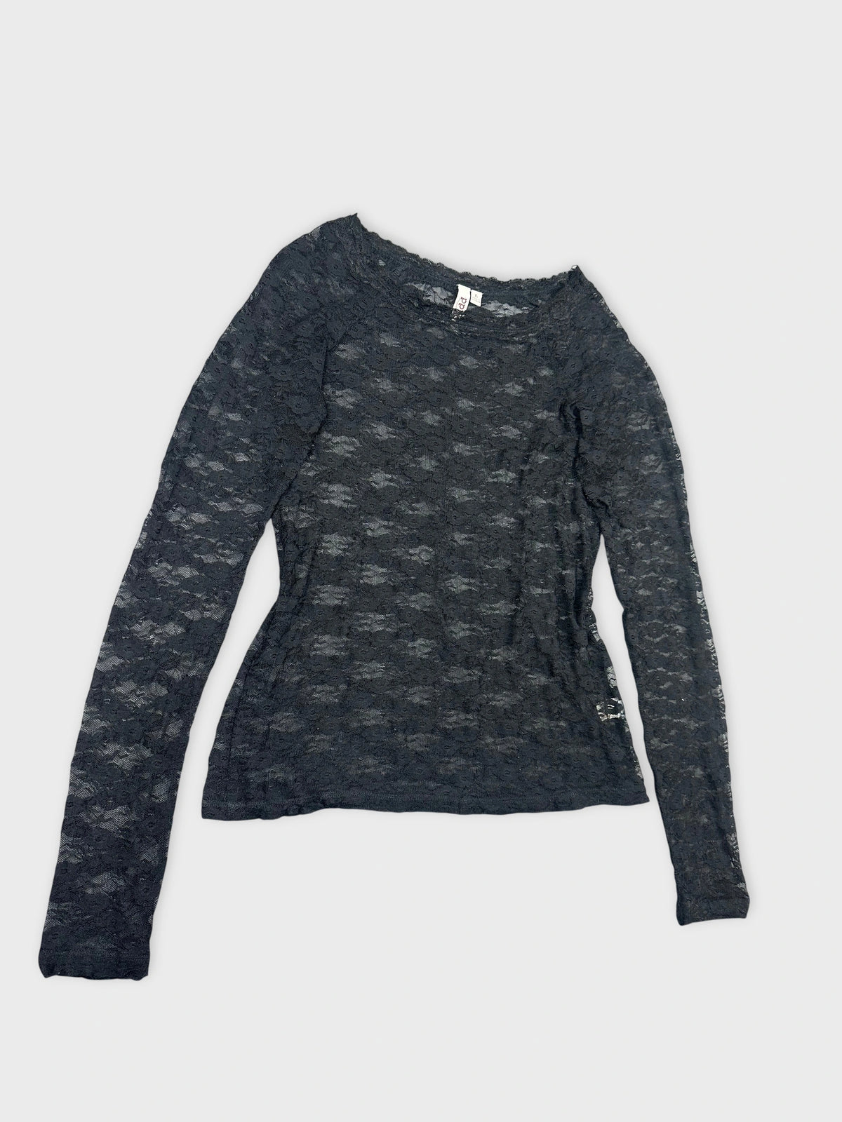 Detail view of a long sleeve black lace blouse.