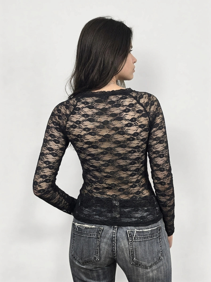 Back view of a black long sleeve blouse with lace pattern.