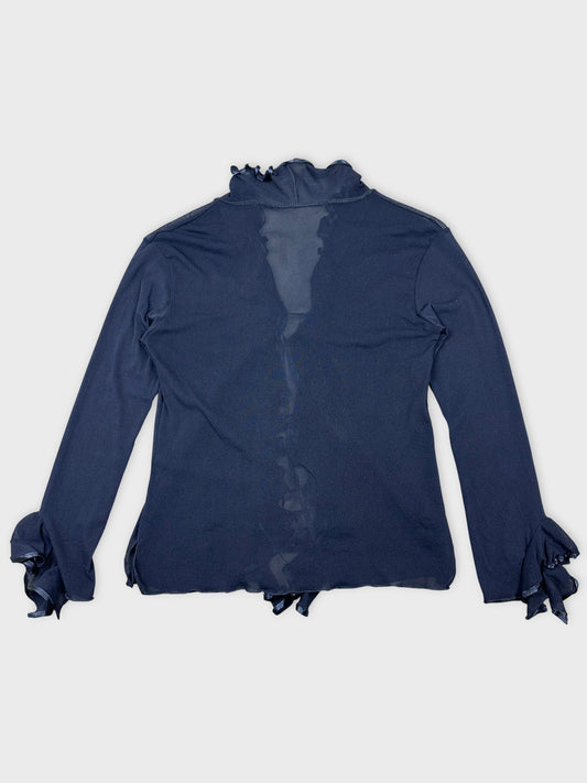 Back view of a long sleeve navy shirt with ruffled cuffs