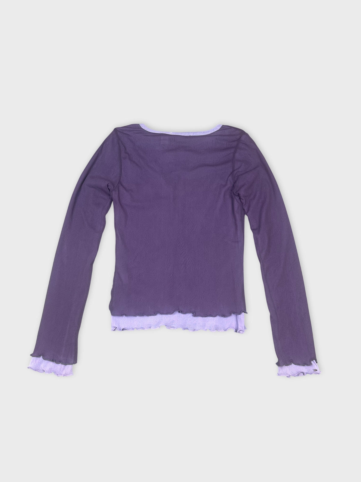 Back view of a purple long sleeve shirt with ruffled trim.
