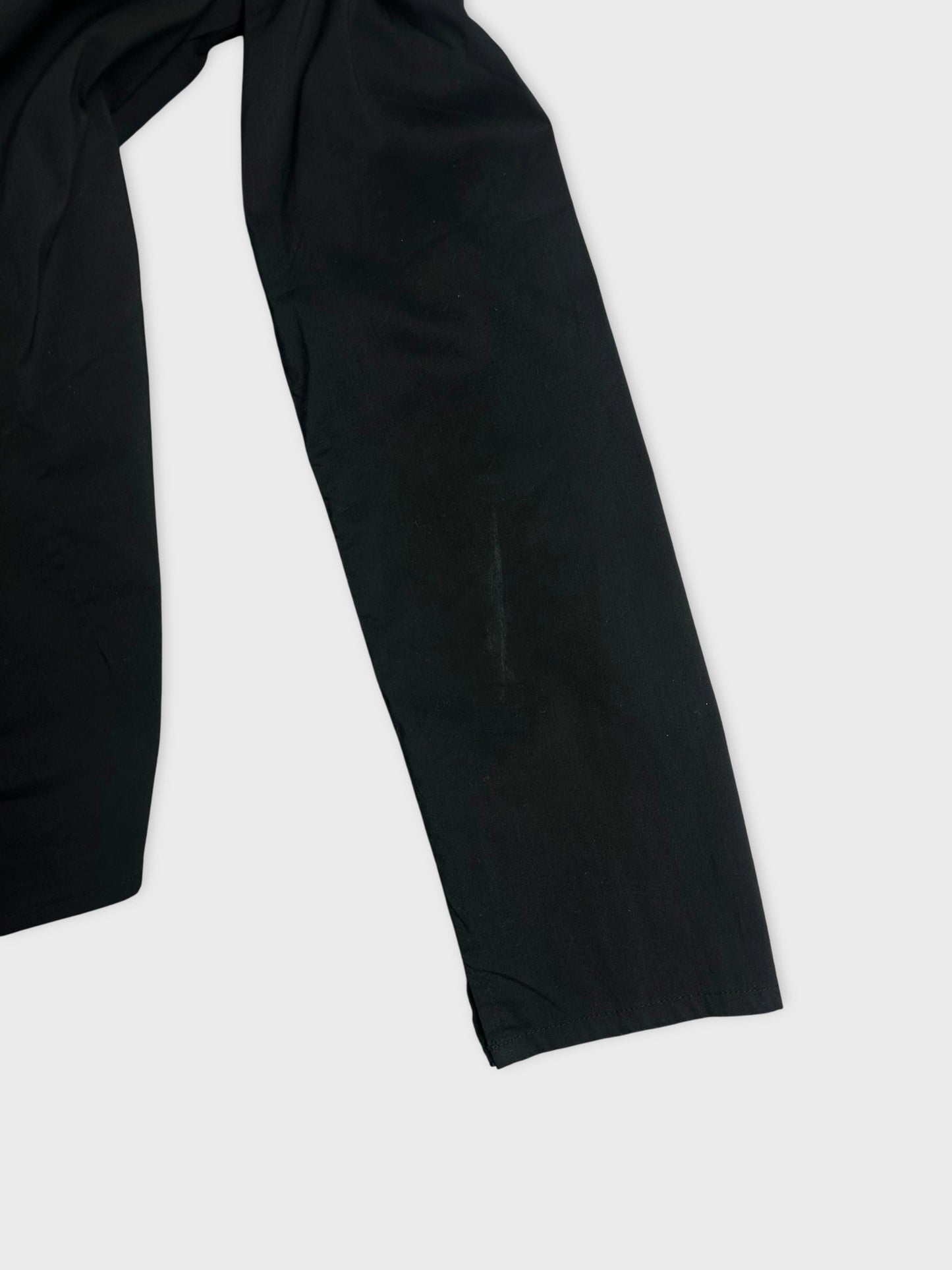 Black long sleeve shirt detail view highlighting right sleeve back side line