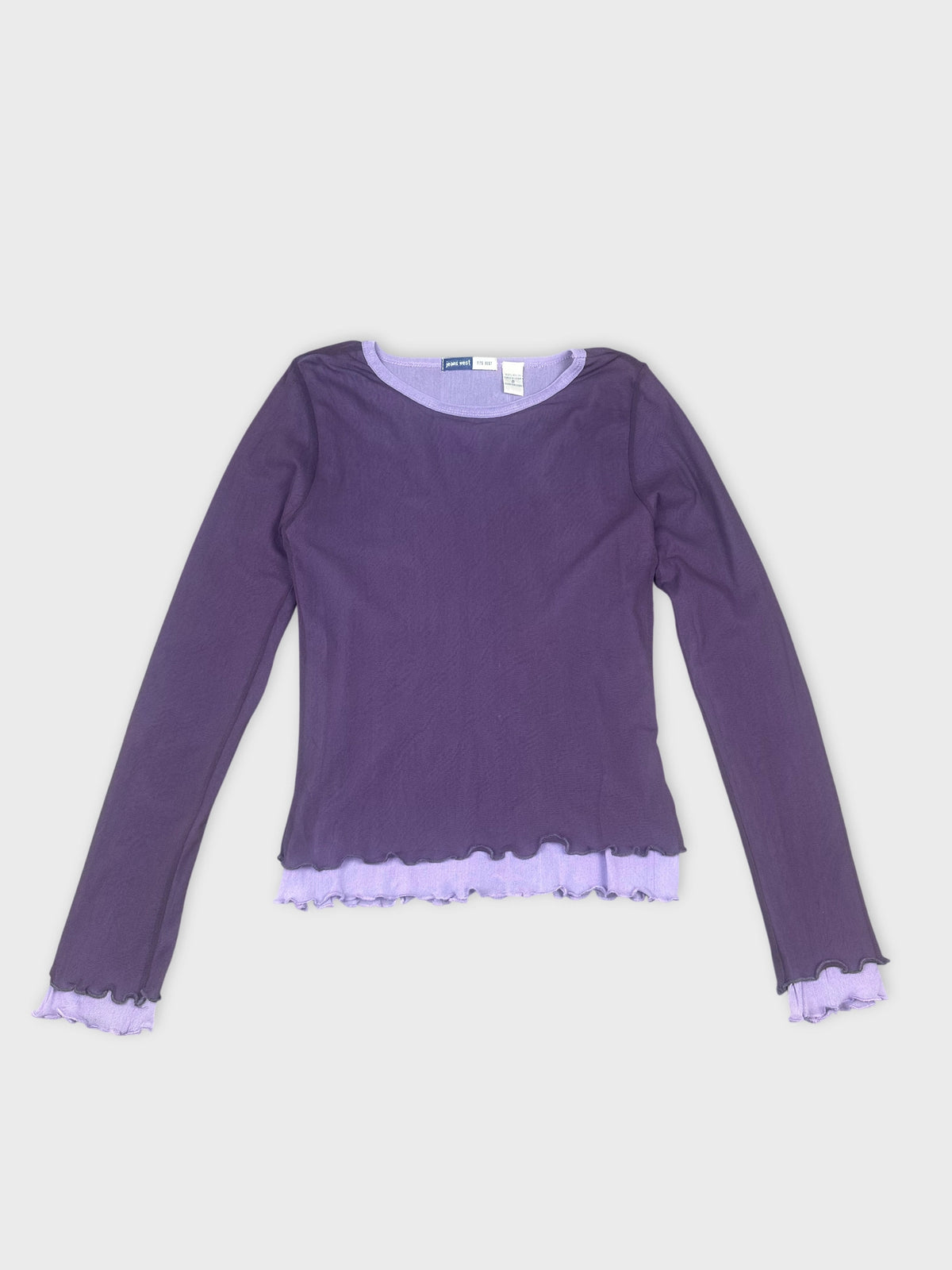 Front view of a purple long sleeve shirt featuring a ruffled hem.