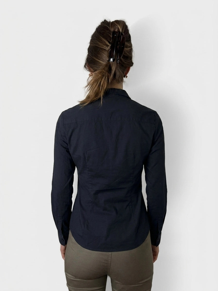 Back view of a navy long sleeve shirt featuring a classic collar.