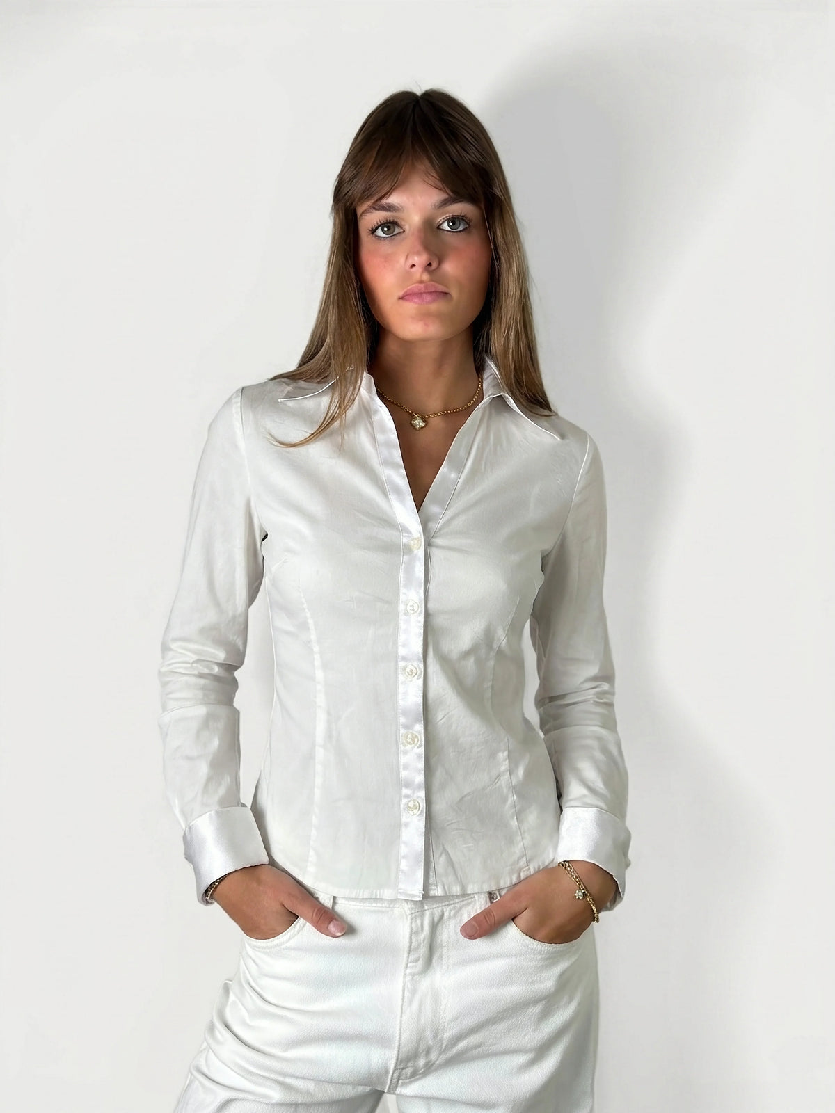 Front view of a white long sleeve shirt featuring a button-down design.