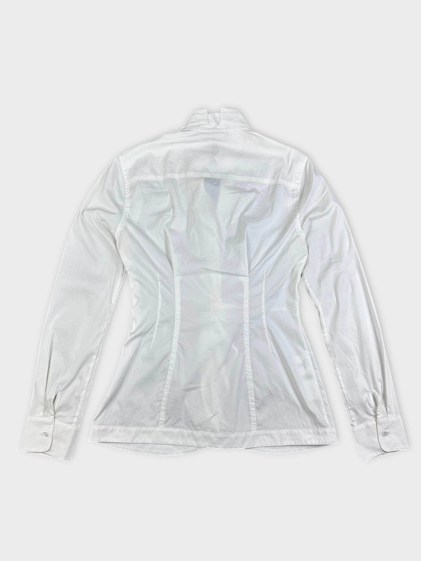 Back view of a white long sleeve top with tailored seams and buttoned cuffs.