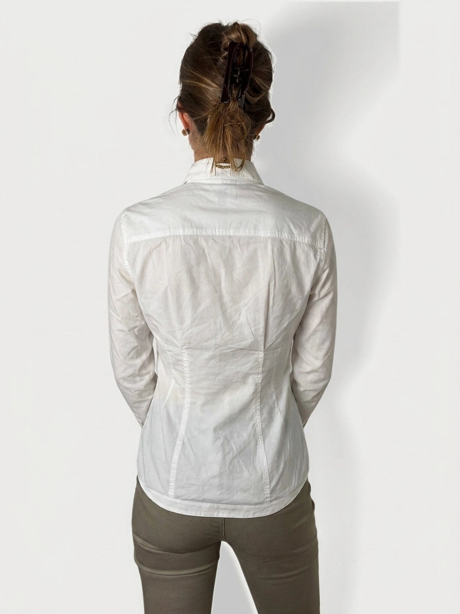 Back view of a white long sleeve top with tailored shape.