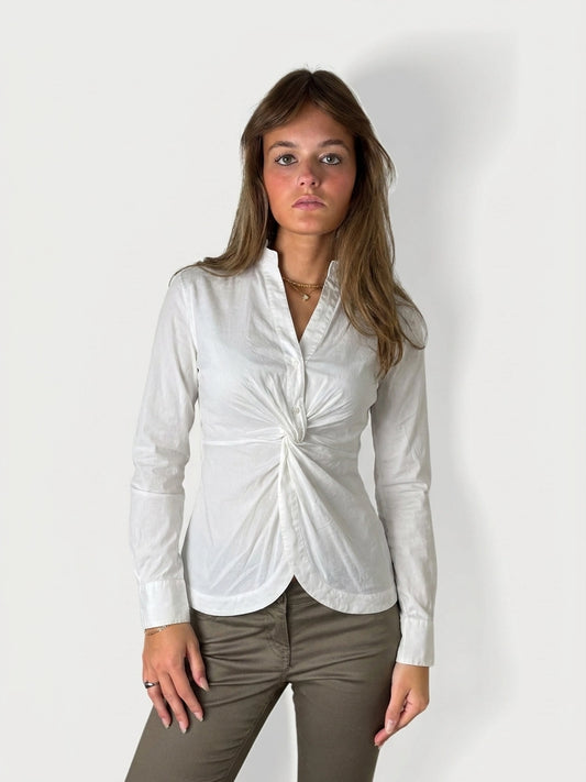 Women's long sleeve top in white with a twist detail, front view.