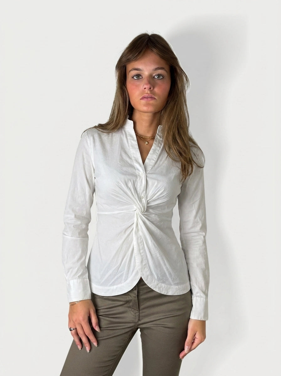 Women's long sleeve top in white with a twist detail, front view.